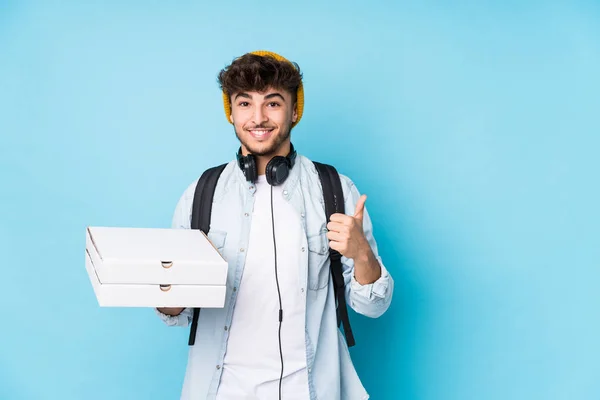 Young Arab Student Man Holding Pizzas Isolated Smiling Raising Thumb — 스톡 사진