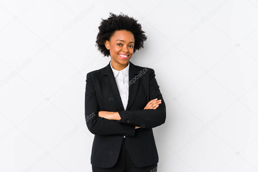 Middle aged african american business  woman against a white background isolated who feels confident, crossing arms with determination.