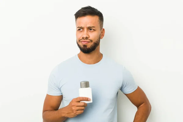 Young South Asian Man Holding Shave Cream Confused Feels Doubtful — Stock Photo, Image
