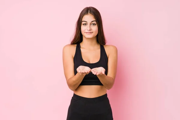 Young Caucasian Fitness Woman Doing Sport Isolated Holding Something Palms — Stok fotoğraf