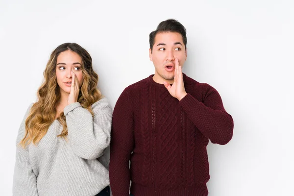 Young Couple Posing White Background Saying Secret Hot Braking News — 스톡 사진