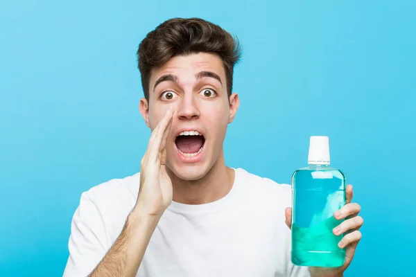 Young Caucasian Man Holding Mouthwash Shouting Excited Front — Stock Photo, Image