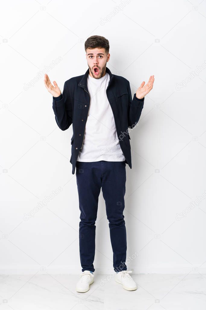 Full body young caucasian man isolated surprised and shocked.