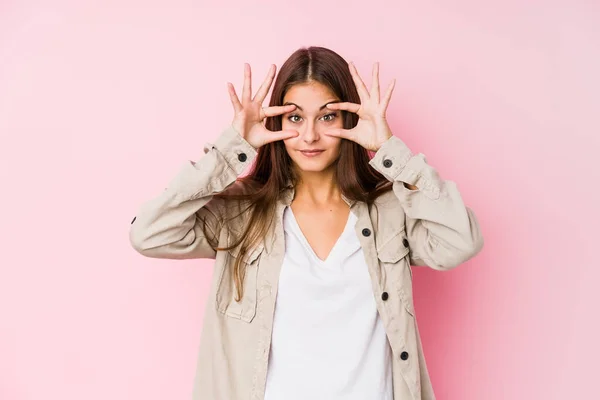 Giovane Donna Caucasica Posa Uno Sfondo Rosa Tenendo Gli Occhi — Foto Stock