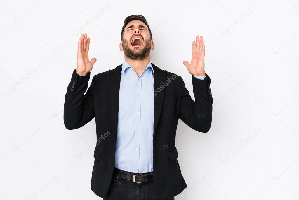 Young caucasian business man against a white background isolated screaming to the sky, looking up, frustrated.