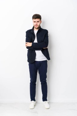 Tam vücut Kafkasyalı genç adam hoşnutsuzluk içinde somurtan yüzü izole, kollarını bağlı tutuyor..