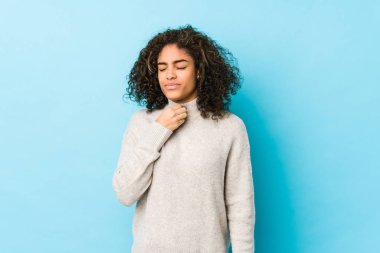 Genç Afro-Amerikan kıvırcık saçlı kadın virüs ya da enfeksiyon yüzünden boğaz ağrısı çekiyor..