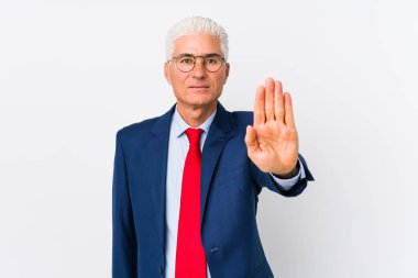 Middle aged caucasian business man isolated standing with outstretched hand showing stop sign, preventing you.