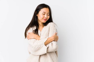 Young chinese woman isolated hugs, smiling carefree and happy.