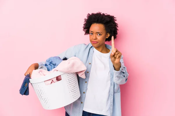 Middle Age African American Woman Doing Laundry Isolated Showing Number — ストック写真