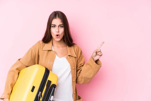 Joven Viajera Caucásica Sosteniendo Una Maleta Aislada Señalando Hacia Lado —  Fotos de Stock