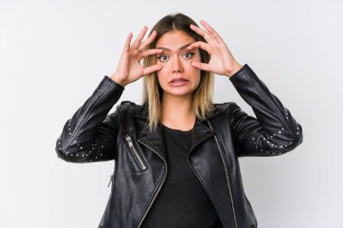 Young caucasian woman wearing a black leather jacket keeping eyes opened to find a success opportunity. clipart