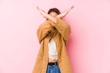 Kafkasyalı genç bir kadın yalnız poz veriyor iki kolu çapraz tutuyor, inkar kavramı.