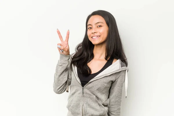 Young Fitness Chinese Woman Joyful Carefree Showing Peace Symbol Fingers — ストック写真