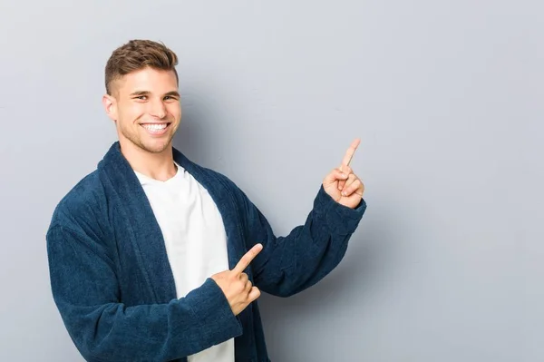 Young Caucasian Man Wearing Pajama Pointing Forefingers Copy Space Expressing — Stock Photo, Image