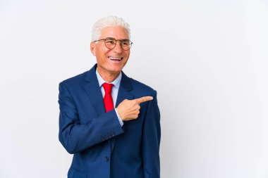 Middle aged caucasian business man isolated smiling and pointing aside, showing something at blank space.
