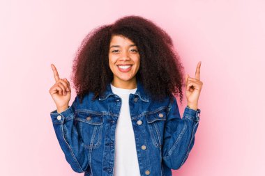 Genç Afro-Amerikalı kadın, iki elini de havaya kaldırarak boş bir alan gösterdiğini söylüyor..