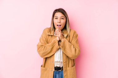 Kafkasyalı genç kadın yalnız poz veriyor şans için dua ediyor, şaşırıyor ve ağzını açıyor..