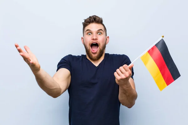 Young Caucasian Man Holding Germany Flag Celebrating Victory Success — Stock Photo, Image