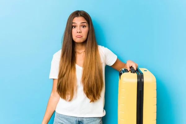 Young Caucasian Woman Holding Travel Suitcase Shrugs Shoulders Open Eyes — Stock Photo, Image
