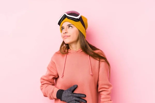 Young Caucasian Woman Wearing Ski Clothes Isolated Touches Tummy Smiles — 스톡 사진