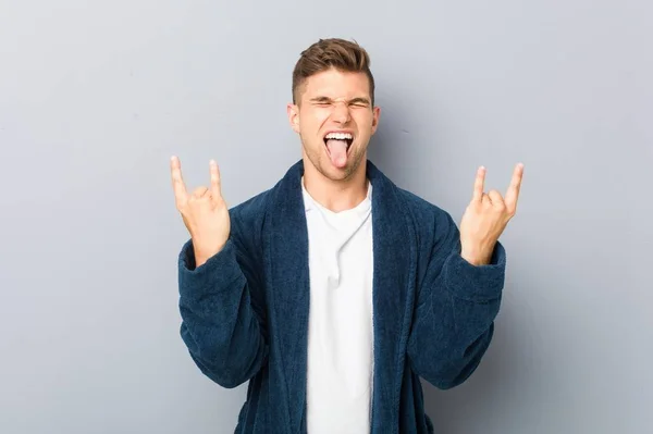 Young Caucasian Man Wearing Pajama Showing Rock Gesture Fingers — 스톡 사진