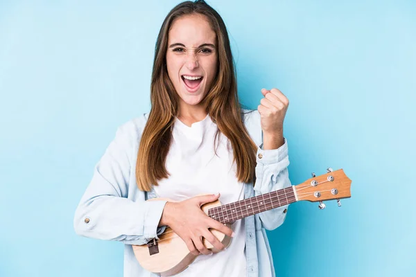 Young Caucasian Woman Holding Ukelele Isolated Cheering Carefree Excited Victory — Stock Photo, Image