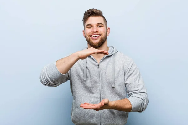 Young Handsome Fitness Man Holding Something Both Hands Product Presentation — Stockfoto
