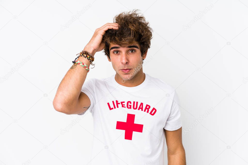 Young caucasian life guard against a white background isolated being shocked, she has remembered important meeting.