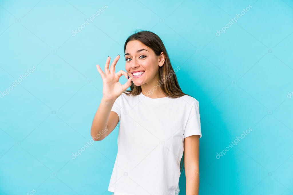 Young caucasian woman  isolated cheerful and confident showing ok gesture.