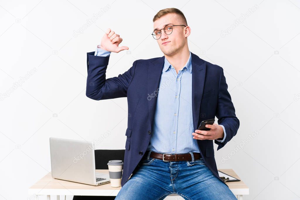 Young business man with a laptop feels proud and self confident, example to follow.