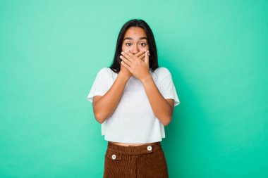 Young mixed race indian woman isolated shocked covering mouth with hands.