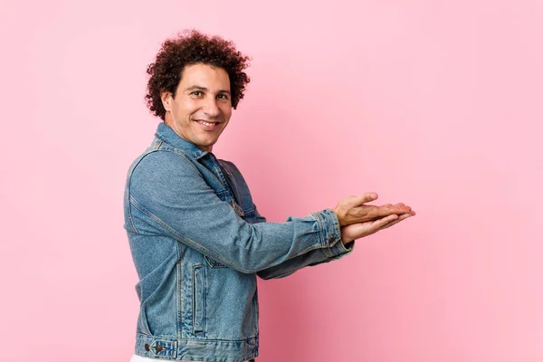 Curly Mature Man Wearing Denim Jacket Pink Background Holding Copy — 스톡 사진