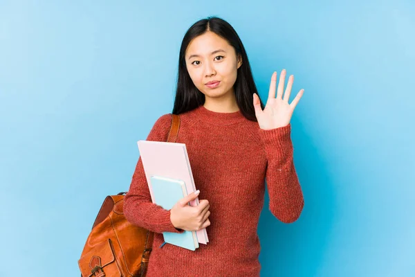 Young chinese student woman isolated smiling cheerful showing number five with fingers.