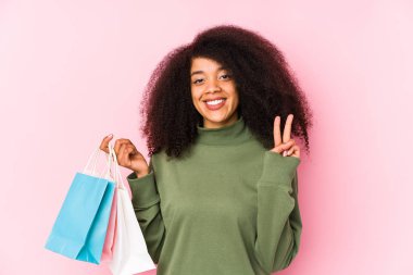 Young afro woman shopping isolated Young afro woman buying 