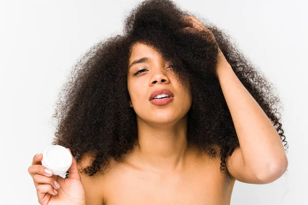 Joven Afro Mujer Sosteniendo Una Crema Hidratante Aislado Siendo Sorprendido — Foto de Stock