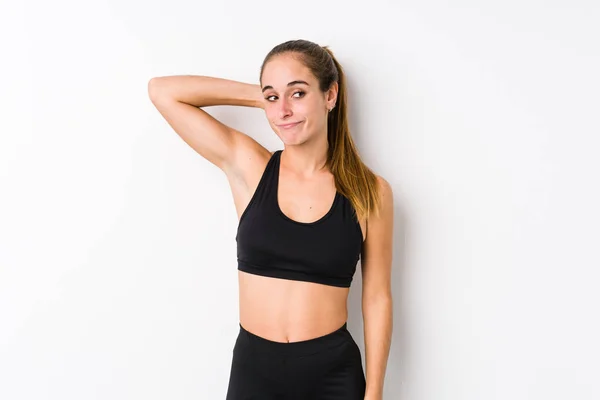 Jonge Blanke Fitness Vrouw Poseren Een Witte Achtergrond Aanraken Achterkant — Stockfoto