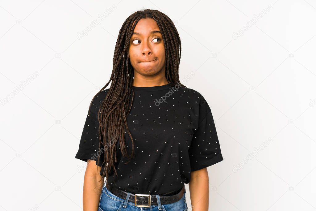 Young african american woman isolated on white background confused, feels doubtful and unsure.