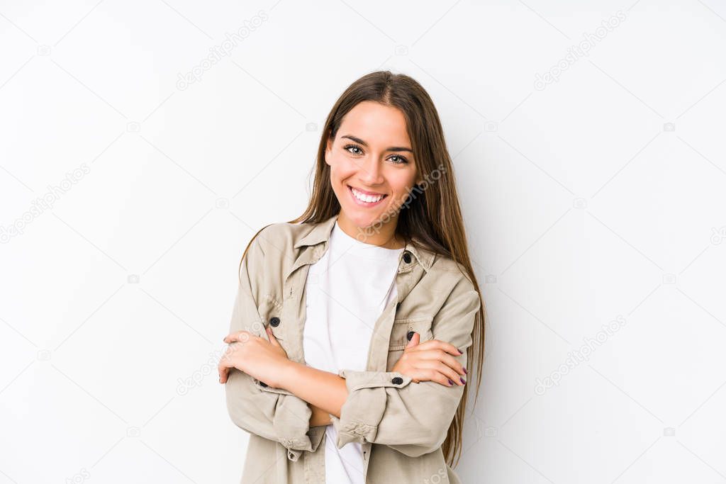Young caucasian woman  isolated who feels confident, crossing arms with determination.