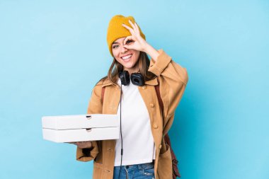 Kafkasyalı genç bir kadın pizza tutuyor. Heyecanlı. Gözünü dört aç..