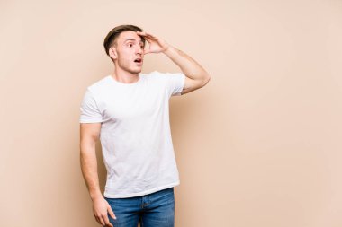 Kafkasyalı genç adam yalnız poz veriyor. Uzağa bakıyor, elini alnına koyuyor..