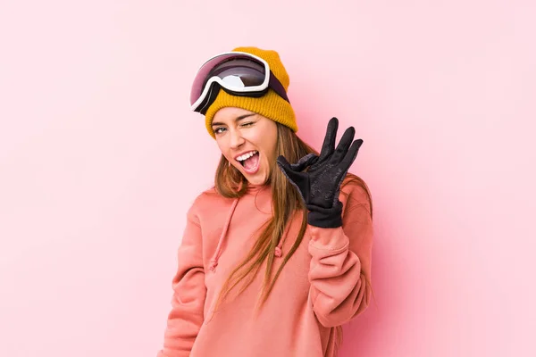 Young Caucasian Woman Wearing Ski Clothes Isolated Winks Eye Holds — 스톡 사진