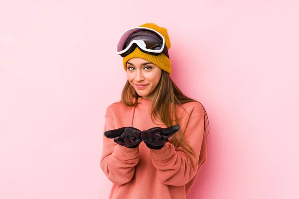 Young Caucasian Woman Wearing Ski Clothes Isolated Holding Something Palms — 스톡 사진