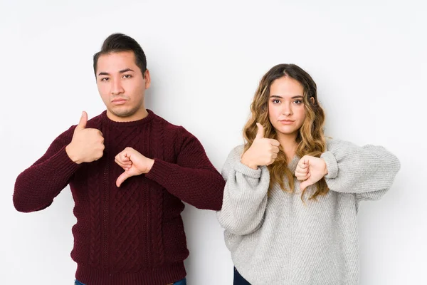 Young Couple Posing White Background Showing Thumbs Thumbs Difficult Choose — 스톡 사진