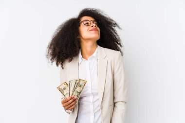 Young afro business woman holding a credit car isolated Young afro business woman holding a credit cardreaming of achieving goals and purposes