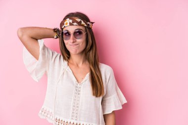 Young hipster caucasian woman isolated touching back of head, thinking and making a choice.