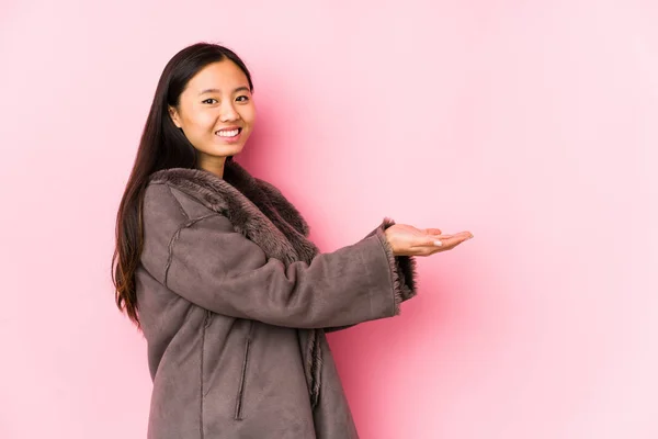 Young Chinese Woman Wearing Coat Isolated Holding Copy Space Palm — 스톡 사진