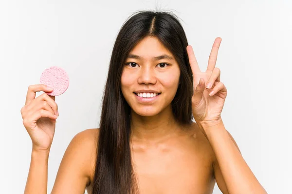 Young Chinese Woman Holding Facial Disk Isolated Showing Victory Sign — Stock Photo, Image