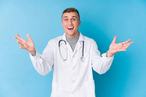 Young Caucasian Doctor Man Receiving Pleasant Surprise Excited Raising Hands — Stock Photo, Image