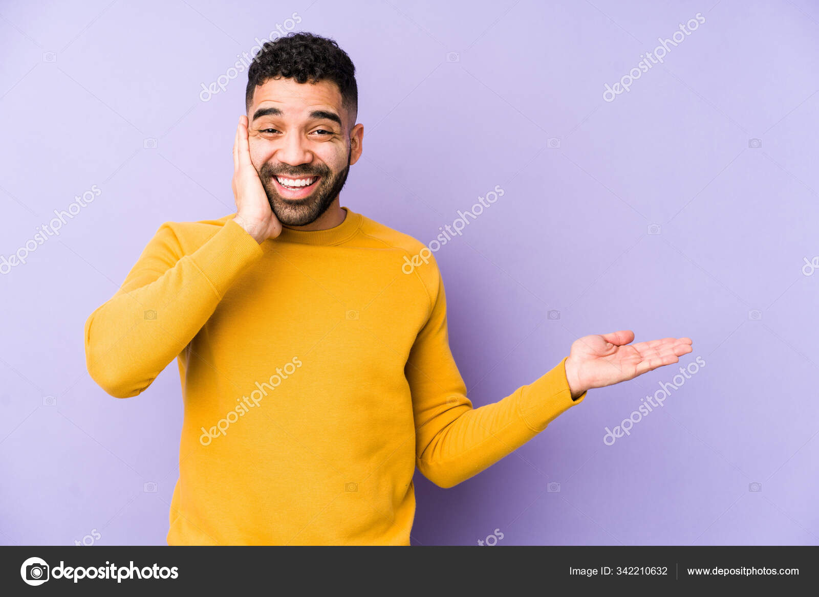 Young Mixed Race Arabic Man Isolated Holds Copy Space Palm Stock Photo by ©AsierRomeroCarballo